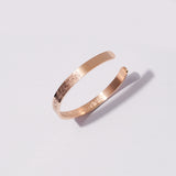 Rose gold Ayatul Kursi Cuff Bracelet on a light gray background