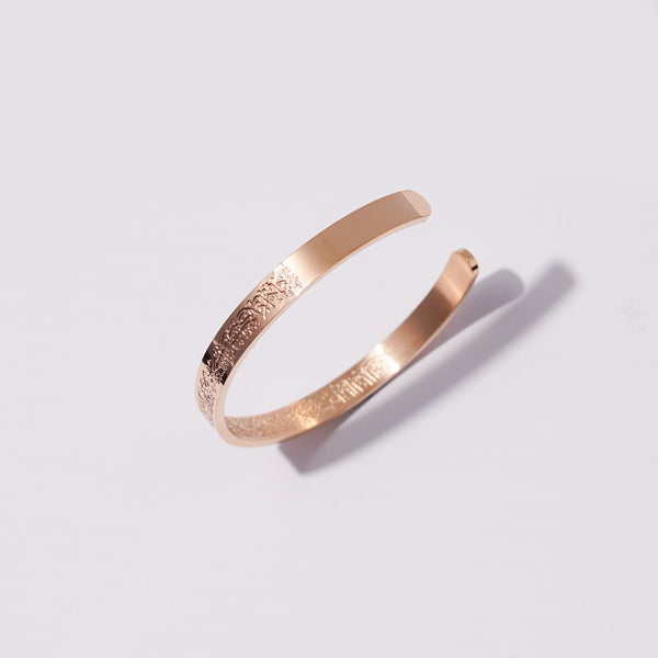 Rose gold Ayatul Kursi Cuff Bracelet on a light gray background